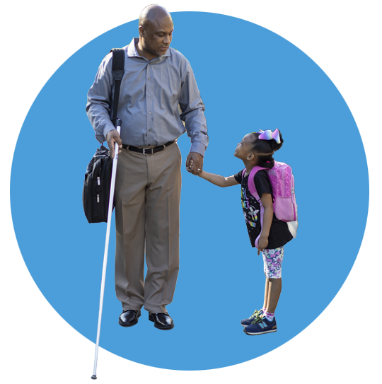 A blind father pauses to talk to his daughter on their walk. His daughter looks up at him while holding his hand.